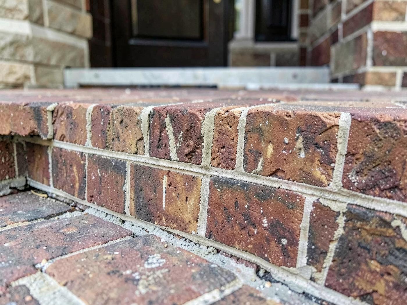 Close view of professional front step masonry repair